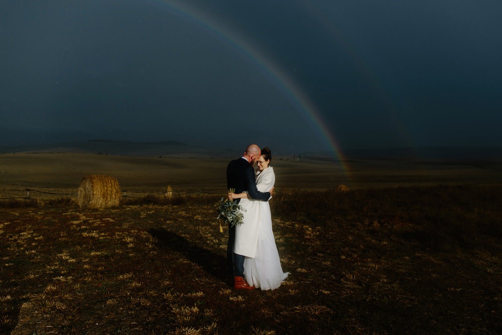 Rainbow sun shower wedding portrait