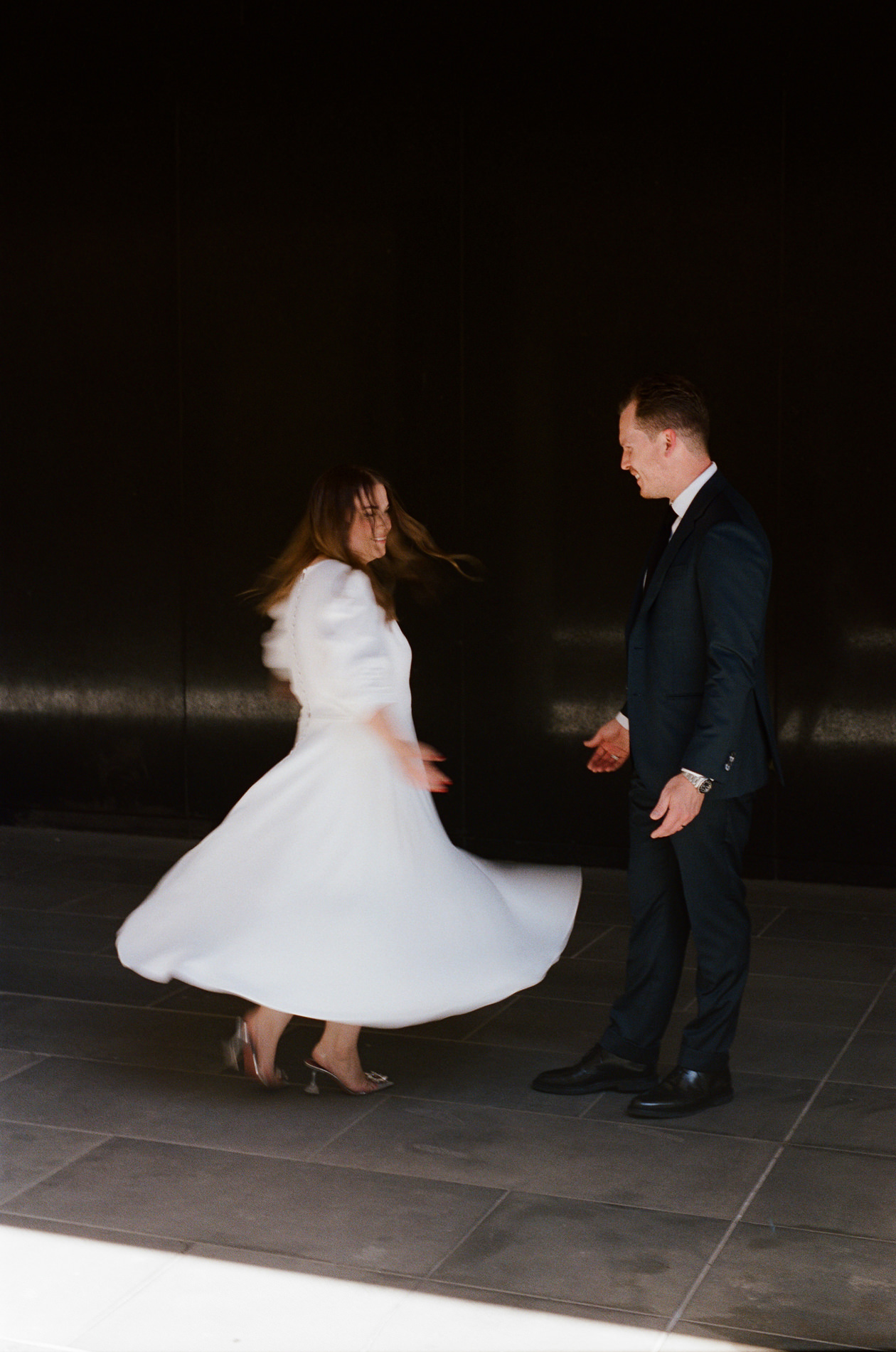 A photo of a bride twirling in Melbourne, in a Carte Blanche bride wedding dress.