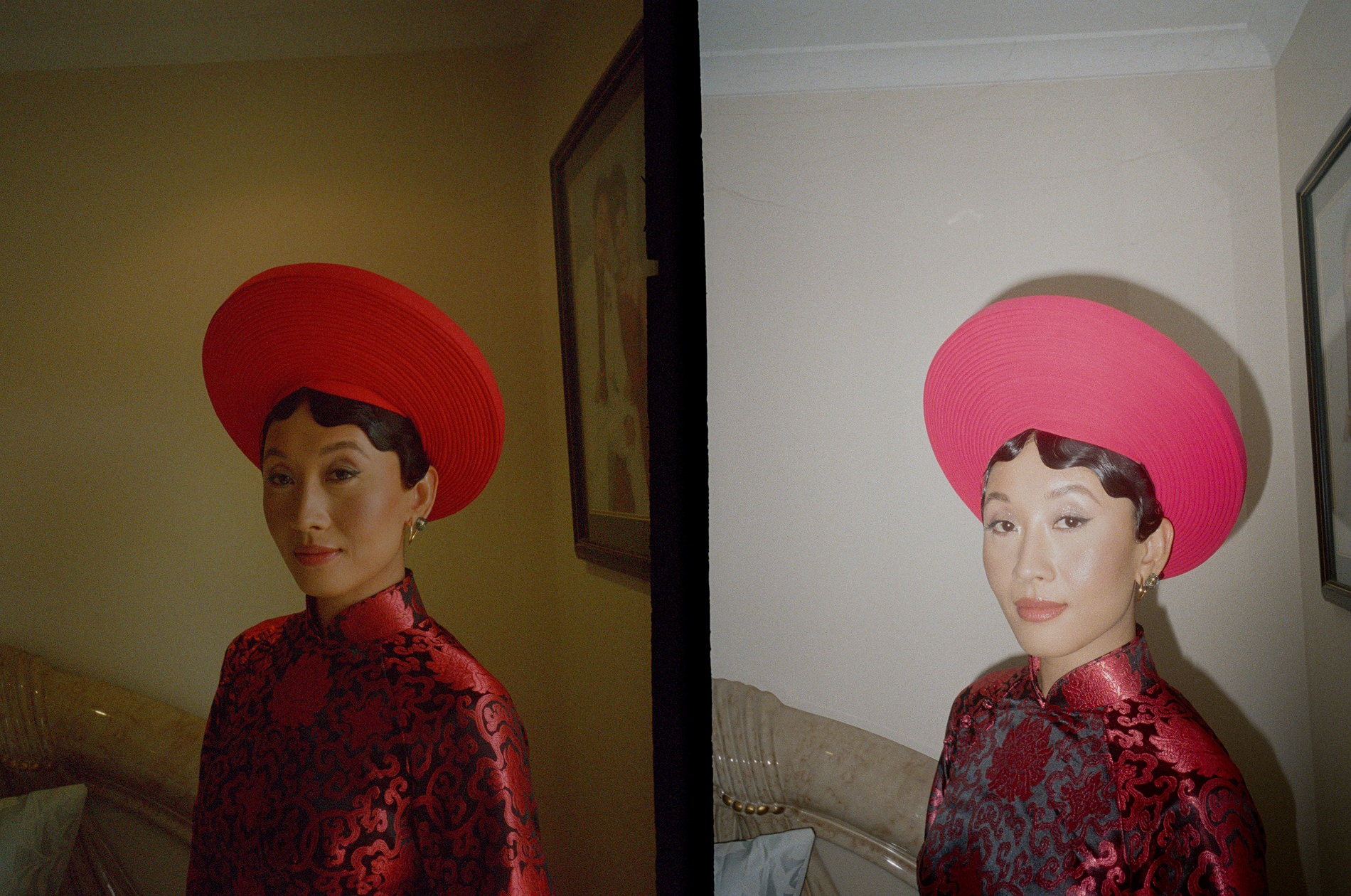 35mm analog film photograph of a bride in a traditional Vietnamese áo dài, wearing a striking red circular hat and a red and black embroidered dress. The image features a diptych, with the bride standing indoors in a softly lit room, showcasing the vibrant colors and intricate details of her attire.
